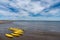 Many sea kayaks and paddleboards on the beach of St. Andrews in Scotland