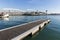 Many seagull waiting on a pier near Rambla de Mar bridge in Barcelona port