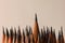 Many sharp graphite pencils on grey background, closeup. Space for text
