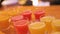 Many shot glasses with alcohol and citrus fruits juice