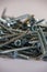 Many silver colored galvanized wood screws