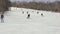 Many skiers coming down slope snow-covered mountain on skis