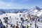 Many skiers and snowboarders stand on the slope before going down in the Austrian curort in Alps.Tirol.