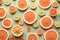 Many sliced fresh grapefruits as background, top view. AI generation