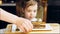 Many slices of cake on a retro-style baking sheet. The chef brings different kinds of cake to the girl's tasting