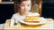 Many slices of cake on a retro-style baking sheet. The chef brings different kinds of cake to the girl's tasting