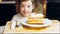 Many slices of cake on a retro-style baking sheet. The chef brings different kinds of cake to the girl's tasting