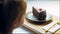 Many slices of cake on a retro-style baking sheet. The chef brings different kinds of cake to the girl's tasting