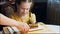 Many slices of cake on a retro-style baking sheet. The chef brings different kinds of cake to the girl's tasting