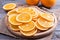 Many slices of fresh orange on a cutting board