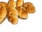 Many small croissants on a white background. Croissants with boiled condensed milk. Confectionery in the kitchen