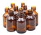 Many small open amber glass oval pharmacy bottles