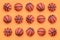 Many small orange balls for basketball sport game lies on texture background of fashion pastel orange color paper in minimal