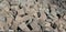 Many small paving stones in a pile, ready to be processed for cobblestone paving of a street. Close-up.