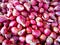 Many small shallots are piled up for sale in the bazaar.