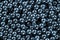 Many small shiny steel balls - abstract blue tinted industrial background