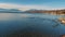 Many species of birds at the lake. Timelapse. Mountain background. Sunny weather.