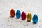 Many standing colored chocolate easter eggs on white background and colorful confetti