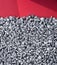 Many steel computer screws. Red background