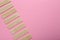 Many sticks of tasty chewing gum on pink background, flat lay. Space for text