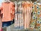 Many style of vintage orange clothes on racks ready for sale in