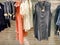 Many style of vintage orange clothes on racks ready for sale in