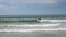 Many surfers on waves at famous surfers spot at Muizenberg beach