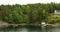 Many Swedish Wooden Sauna Logs Cabins Houses On Island Coast In Summer Cloudy Day