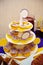 Many sweet birthday cupcakes with flowers and butter cream purple, yellow style