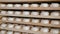 Many sweets white marshmallow stored in wooden racks in the warehouse of the confectionery factory