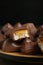 Many tasty chocolate bars with caramel on table, closeup