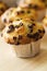 Many tasty homemade vanilla muffins with chocolate chunks on bright white background. Closeup.
