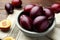 Many tasty ripe plums on table, closeup