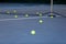 Many tennis balls on the tennis court