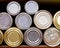 Many tin cans stacked on a pantry shelf in a row