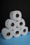 Many toilet paper rolls. Soft hygienic paper. Black blue background