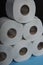 Many toilet paper rolls. Soft hygienic paper. Black blue background