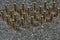 many Tokarev pistol cartridges standing on a gray granite background