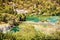 Many tourists are swimming in the river near the waterfalls, Krka, yellow filter