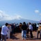 Many tourists on top of mountain Tenjo Yama admire and photograph Mount Fujiyama