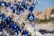 many traditional turkish Evil Eye Bead Amulets on the tree nazar boncuk from blue glass