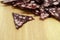 Many triangular pieces of sausage with fat on wooden background