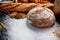 Many type of bread studio shot with . ingredients flour seed  grain all around.photo take with high iso may has some noise and gai