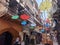 many umbrella decorations are hanging inside an old walled town