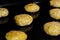 Many uncooked homemade oatmeal cookies on metal sheet in oven