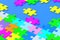 Many unfinished colorful puzzle jiggle pieces on blue background