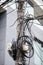 Many unorganised internet and TV cables on a concrete pole in Bucharest