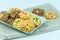 Many variety homemade cookies in plate on fabric and white background.