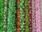 Many various colours flowers abstract pattern backgrounds, artificial flowers and garlands at shop at local market, Religious