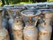 Many various older portable gas cylinders in front of gas store for service